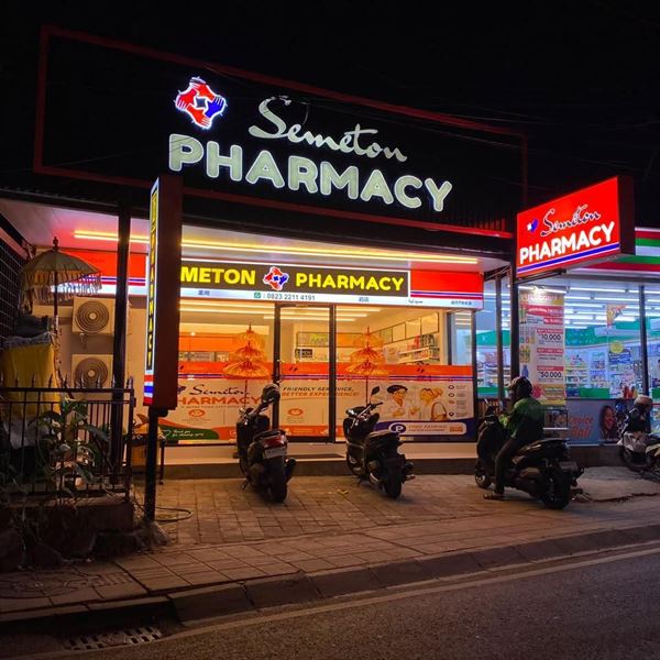 Illuminated Semeton Pharmacy sign at night